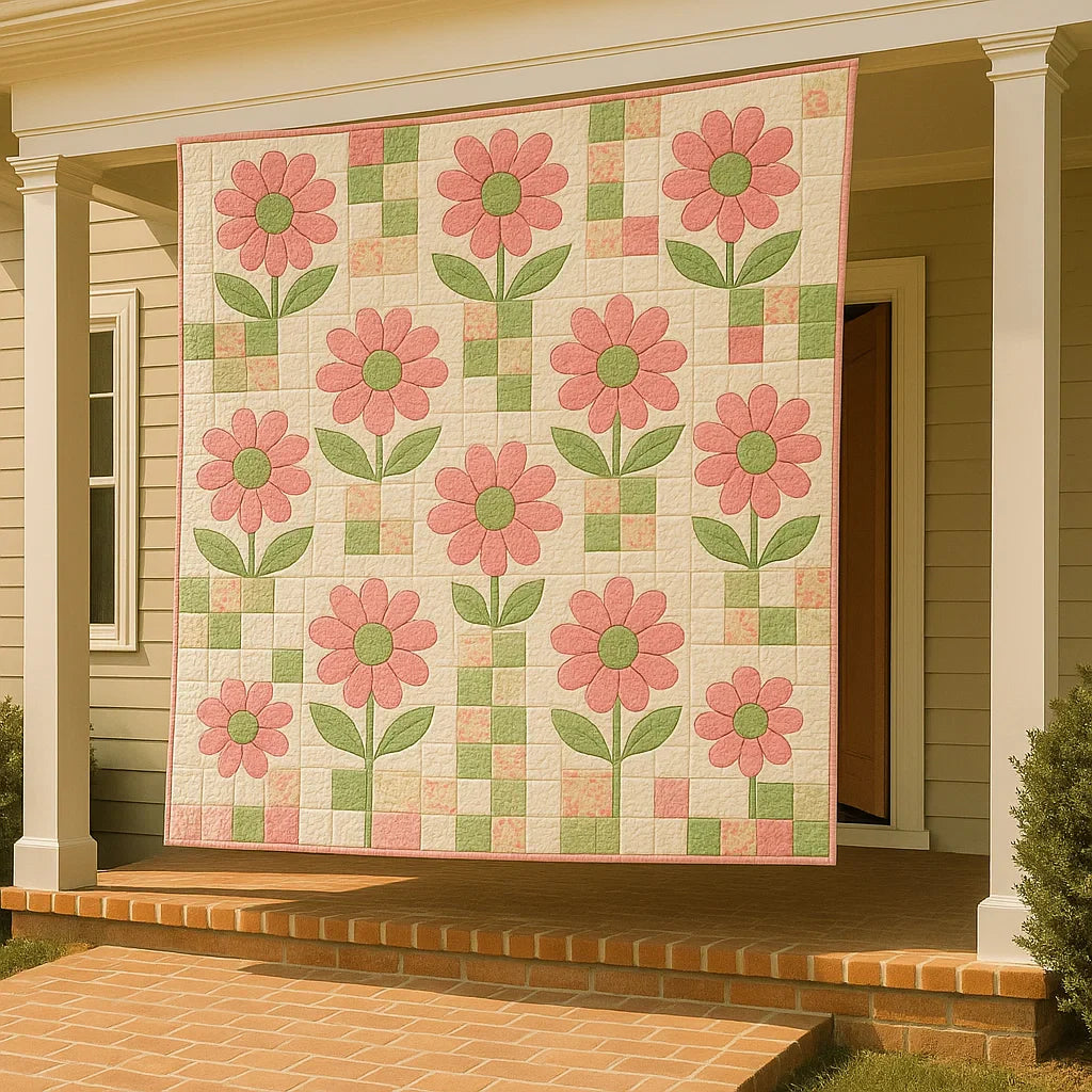 A porch with white columns displays a quilt made from the Posey Pink Downloadable PDF Quilt Pattern, showcasing digital pink flowers and green leaves against the beige house backdrop.