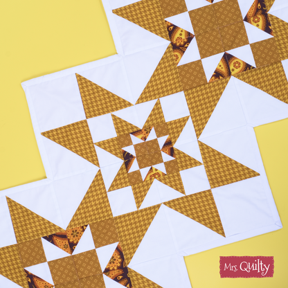 Table Runner Downloadable PDF Quilt Pattern features brown and white star patchwork blocks on a yellow background. Ideal for home decor, this easy-to-download pattern includes the “Mrs. Quilty” label in the bottom right corner.