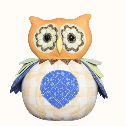 Olive the Owl Downloadable PDF Quilt Pattern features a whimsical owl design with button eyes, patterned wings, a blue heart-shaped patch on its plaid body—perfect for creating your own charming quilted owl.
