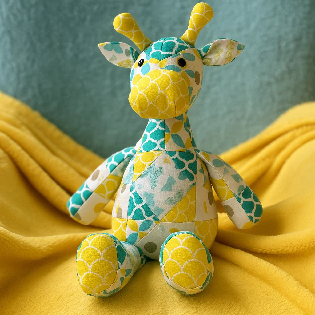 Gigi the Giraffe Downloadable PDF Quilt Pattern features an animal-inspired quilting design in yellow, teal, and white, perfect for creating a playful giraffe quilt to brighten up any space.